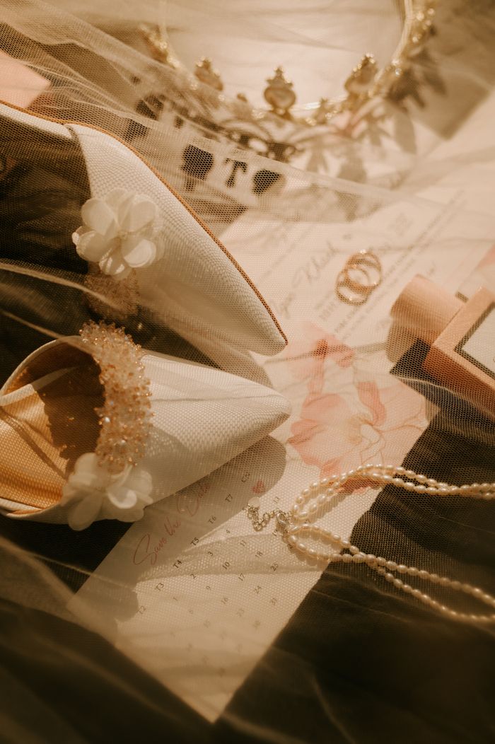 Chic flat lay of bridal shoes, veil, necklace, and headband for wedding inspiration.