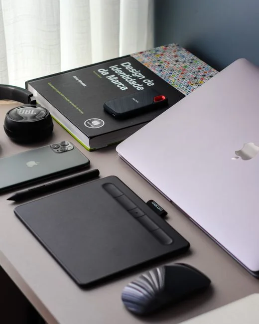 Close-up of an open laptop on a table displaying a website outdoors.